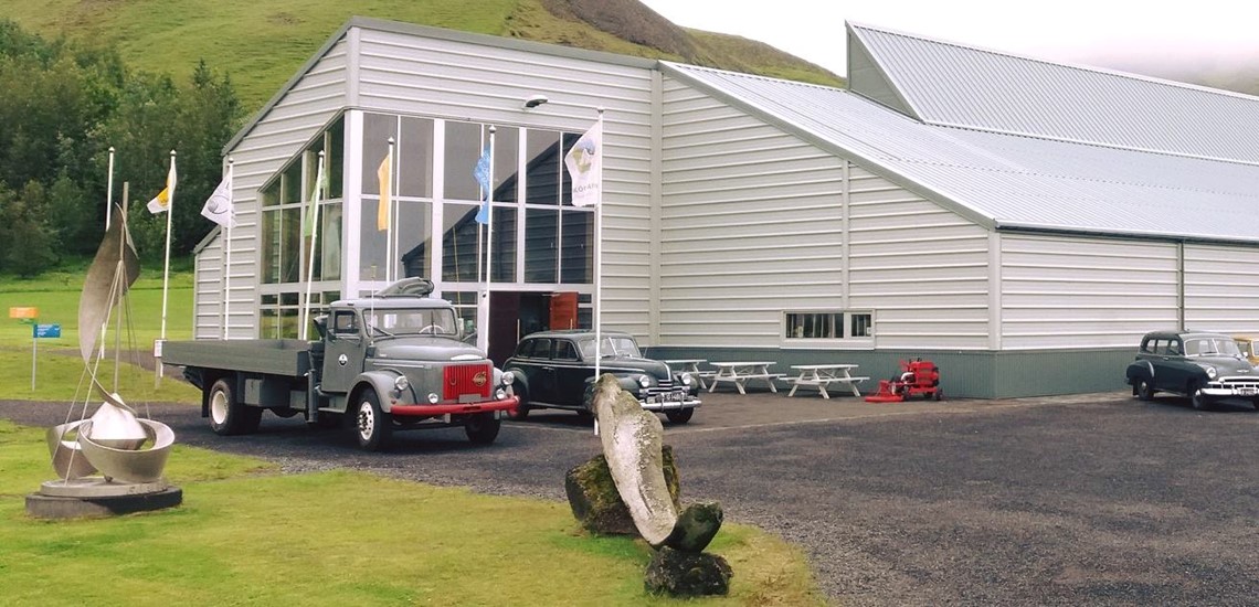 Vintage vehicles outside the Technical Museum building at Skógar Museum.