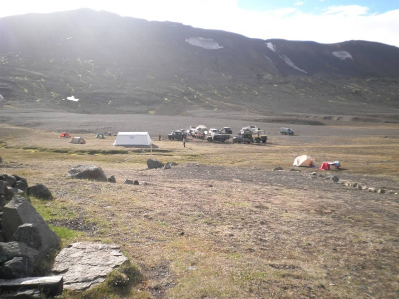 Tents and highland vehicles near Snæfellsskáli below the slopes of Snæfell.