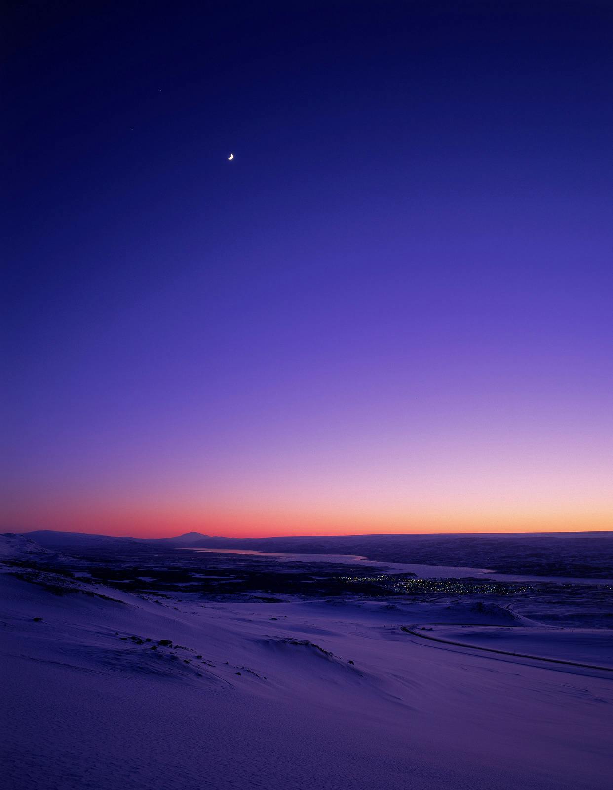 Distant Snæfell and the East Iceland highlands at winter twilight.