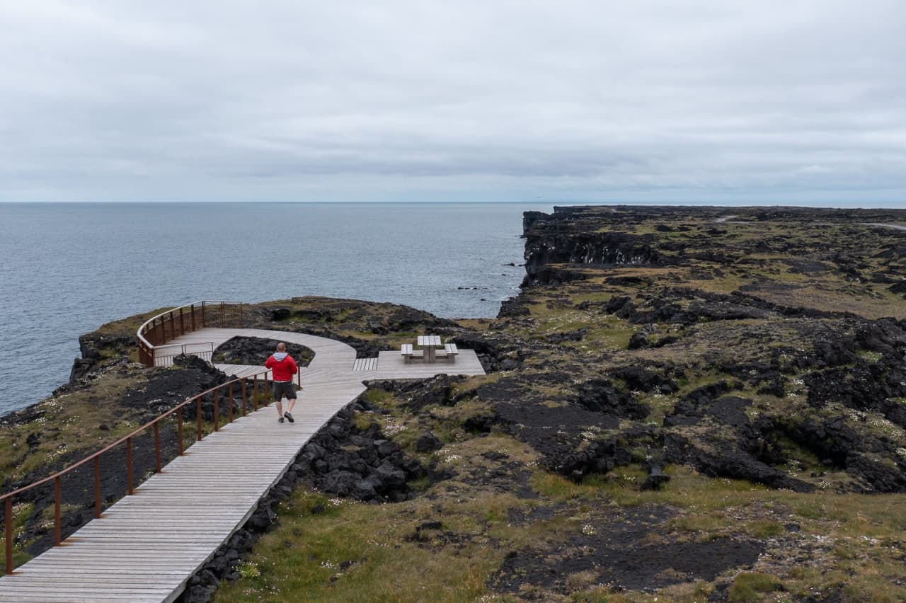 A marked boardwalk beside lava and sea cliffs in Snæfellsjökull National Park.
