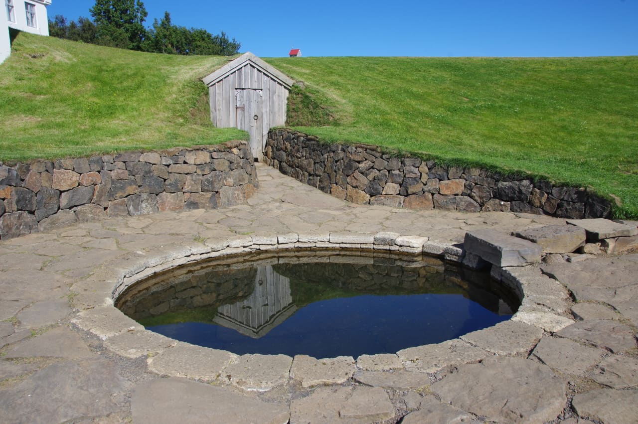 Snorralaug, a stone-lined medieval geothermal pool in Reykholt, West Iceland.