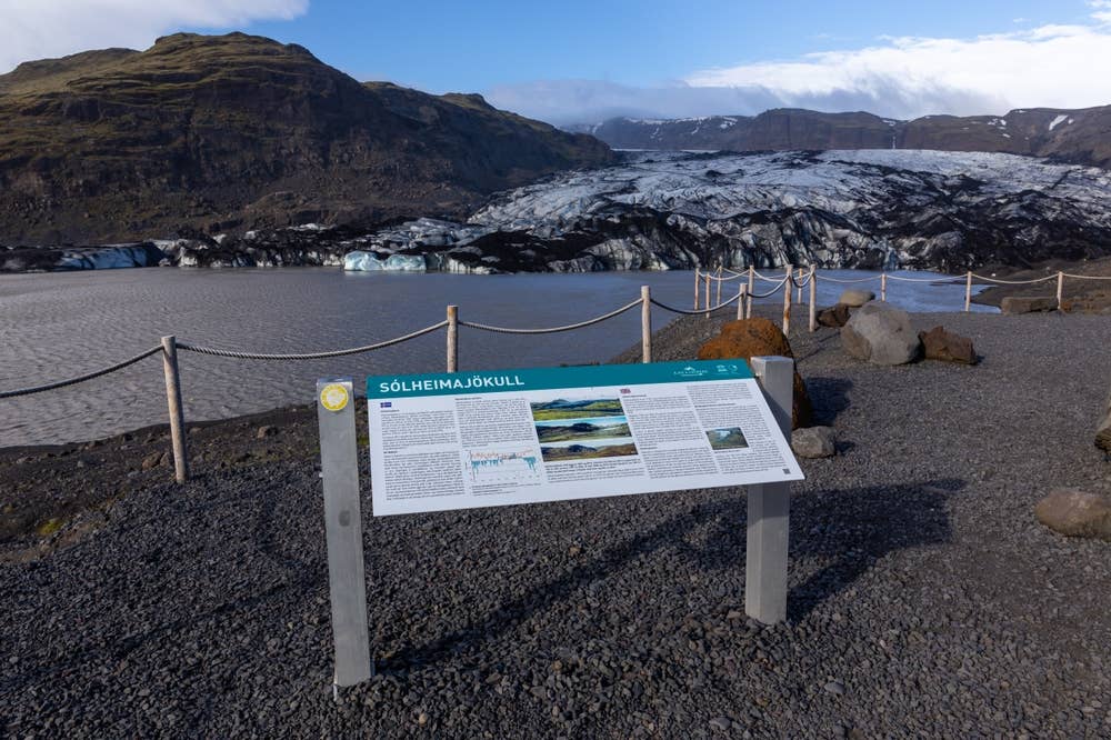 Information sign and rope barrier at the Sólheimajökull Glacier viewpoint beside the lagoon