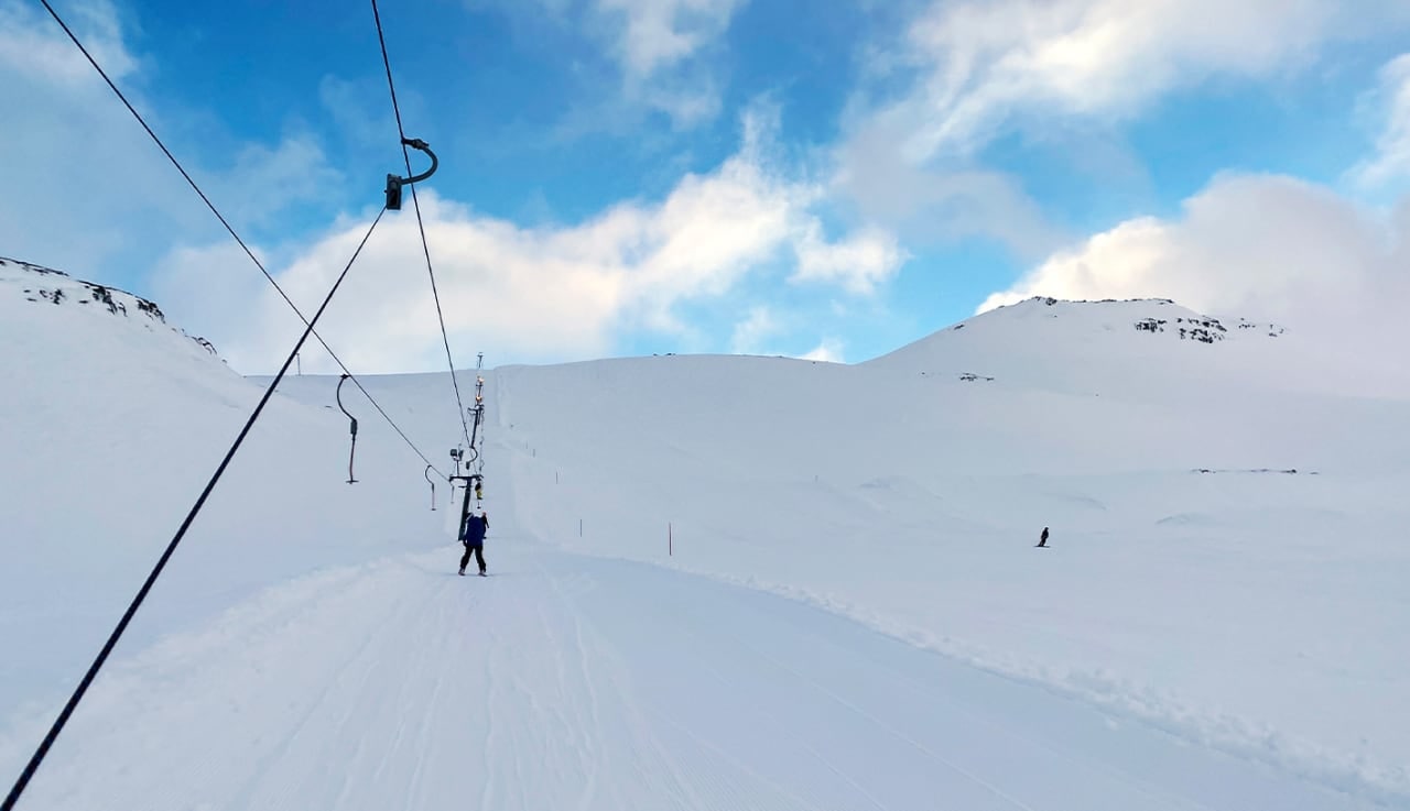 Ski lift line and snowy slope at Stafdalur Ski Station in East Iceland.