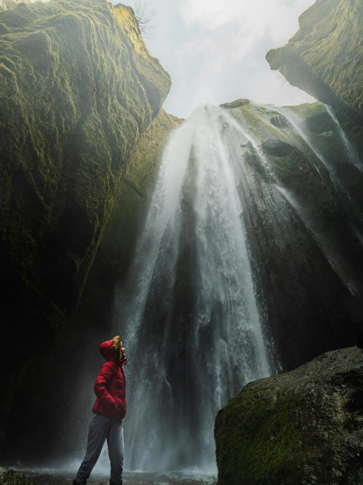 A waterfall dropping into the narrow inner chamber of Stakkholtsgjá canyon.