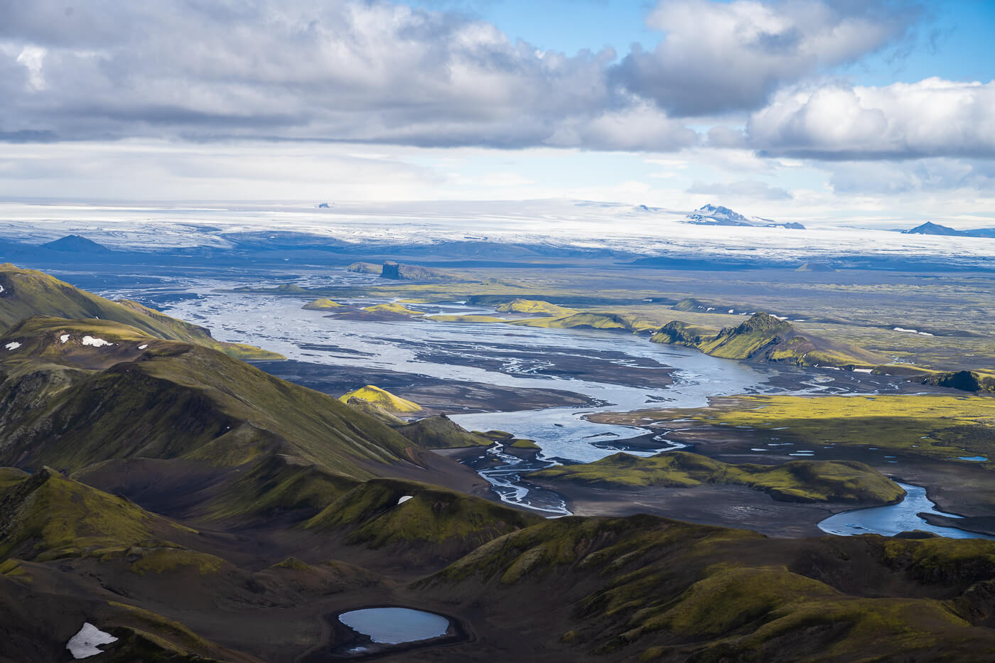View from Sveinstindur toward braided rivers and the Vatnajökull ice cap.