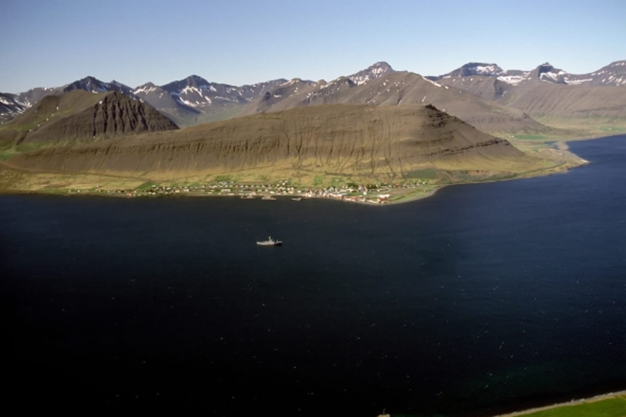 Þingeyri village on the shore of Dýrafjörður below the Westfjords Alps.
