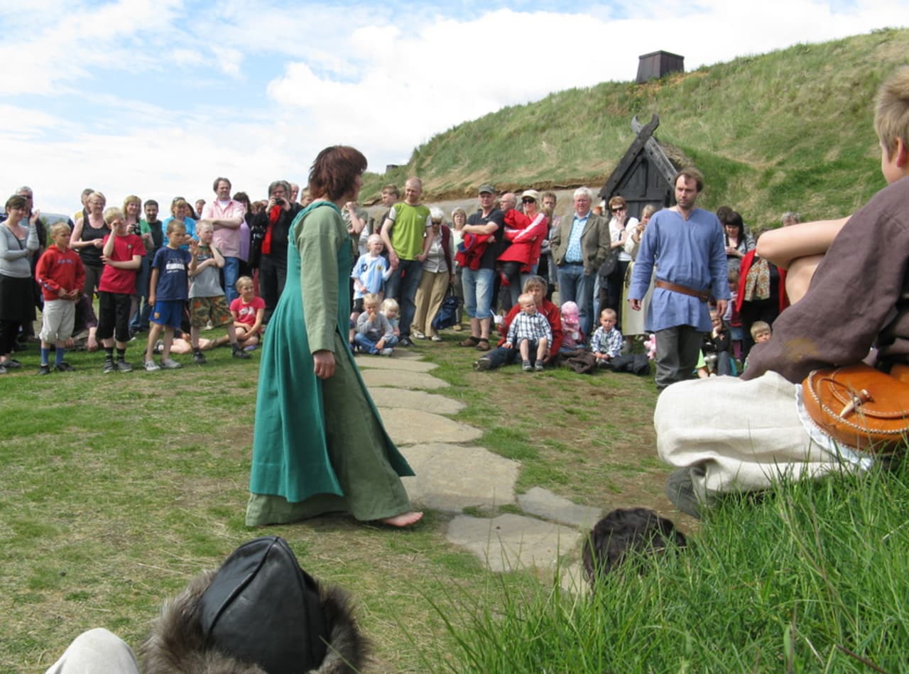 Visitors gathered outside the reconstructed Commonwealth Farm at Stöng in Þjórsárdalur.