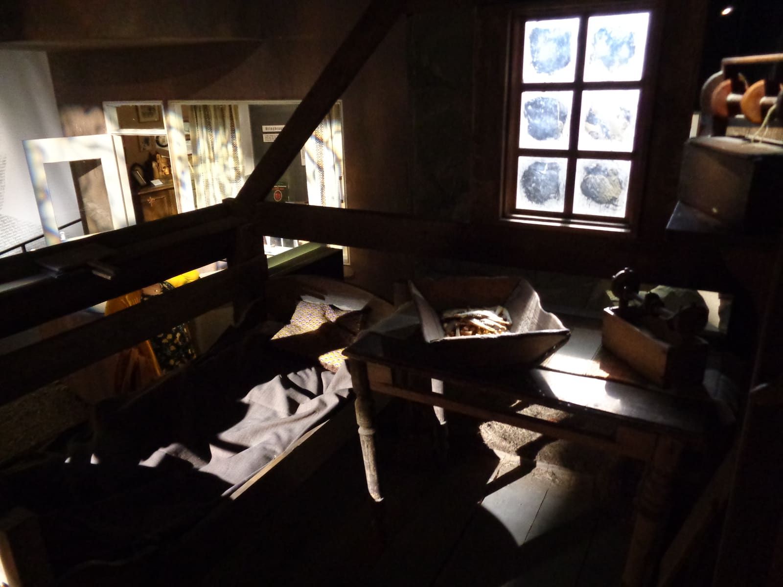 Dim baðstofa-style exhibition room with old household objects inside Þórbergssetur.