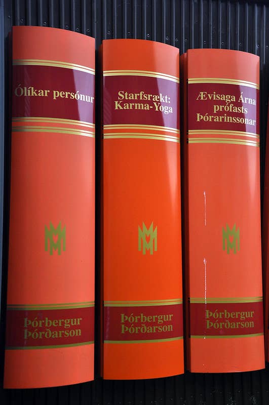 Red book-spine panels on the exterior wall of Þórbergssetur showing Þórbergur Þórðarson titles.