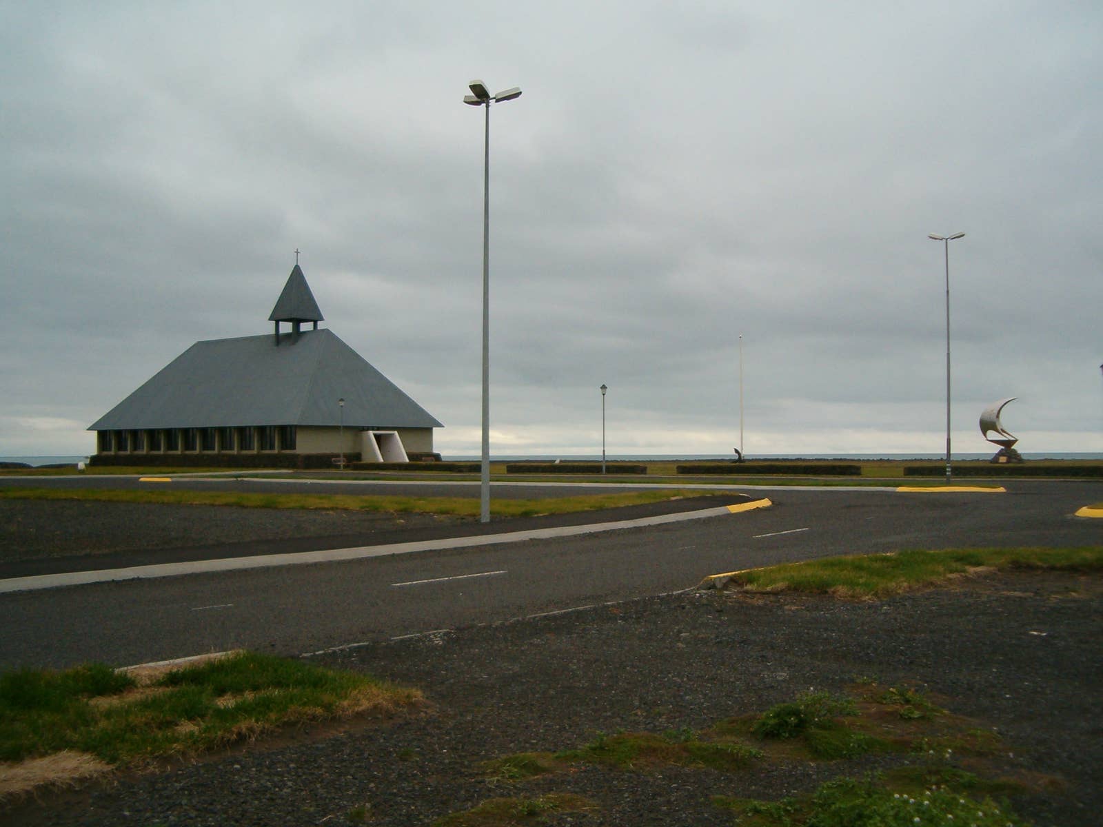 Þorlákskirkja and the road edge near the sea in Þorlákshöfn.