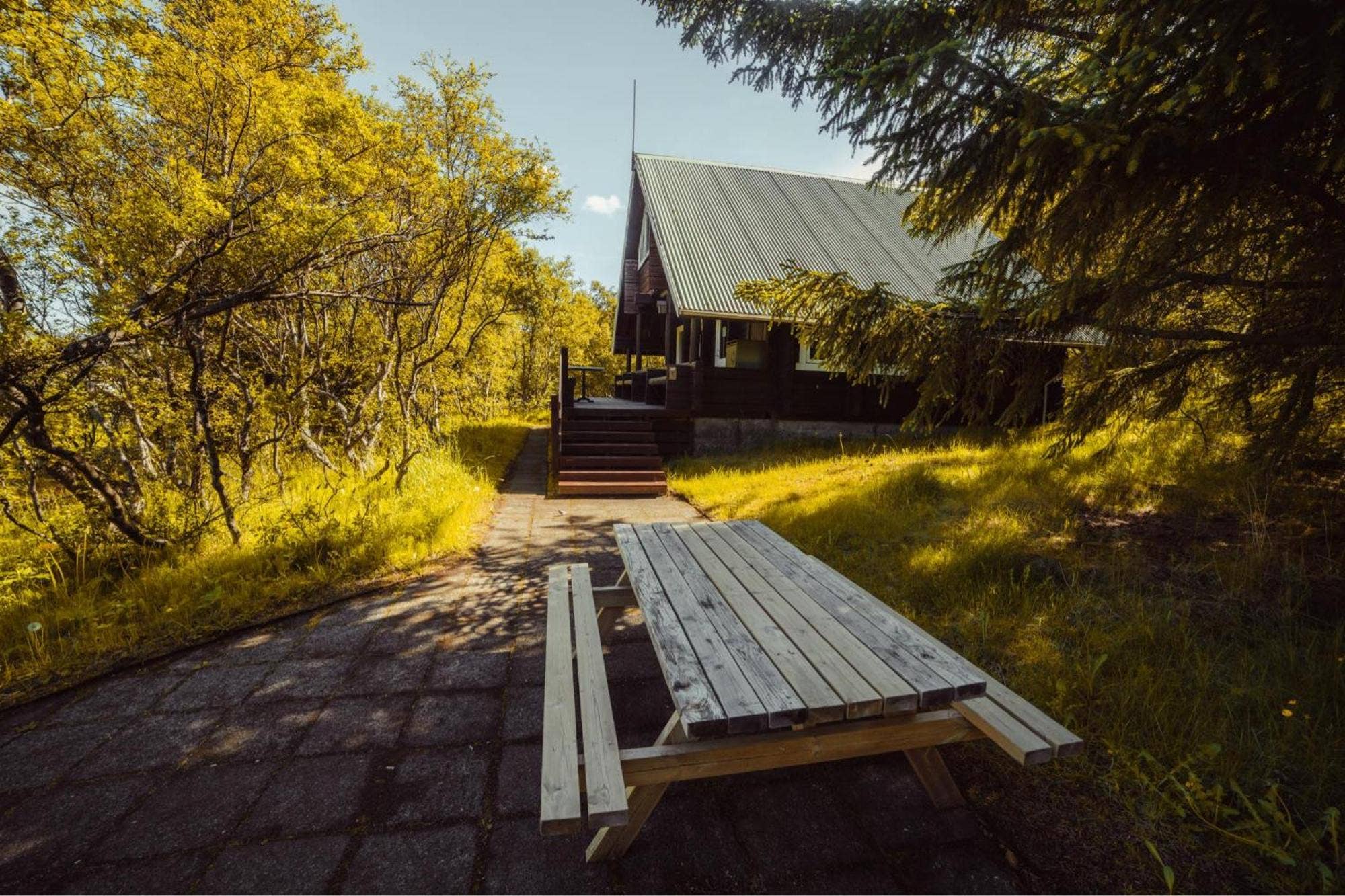Wooden Highland hut among yellow birch trees in Þórsmörk.