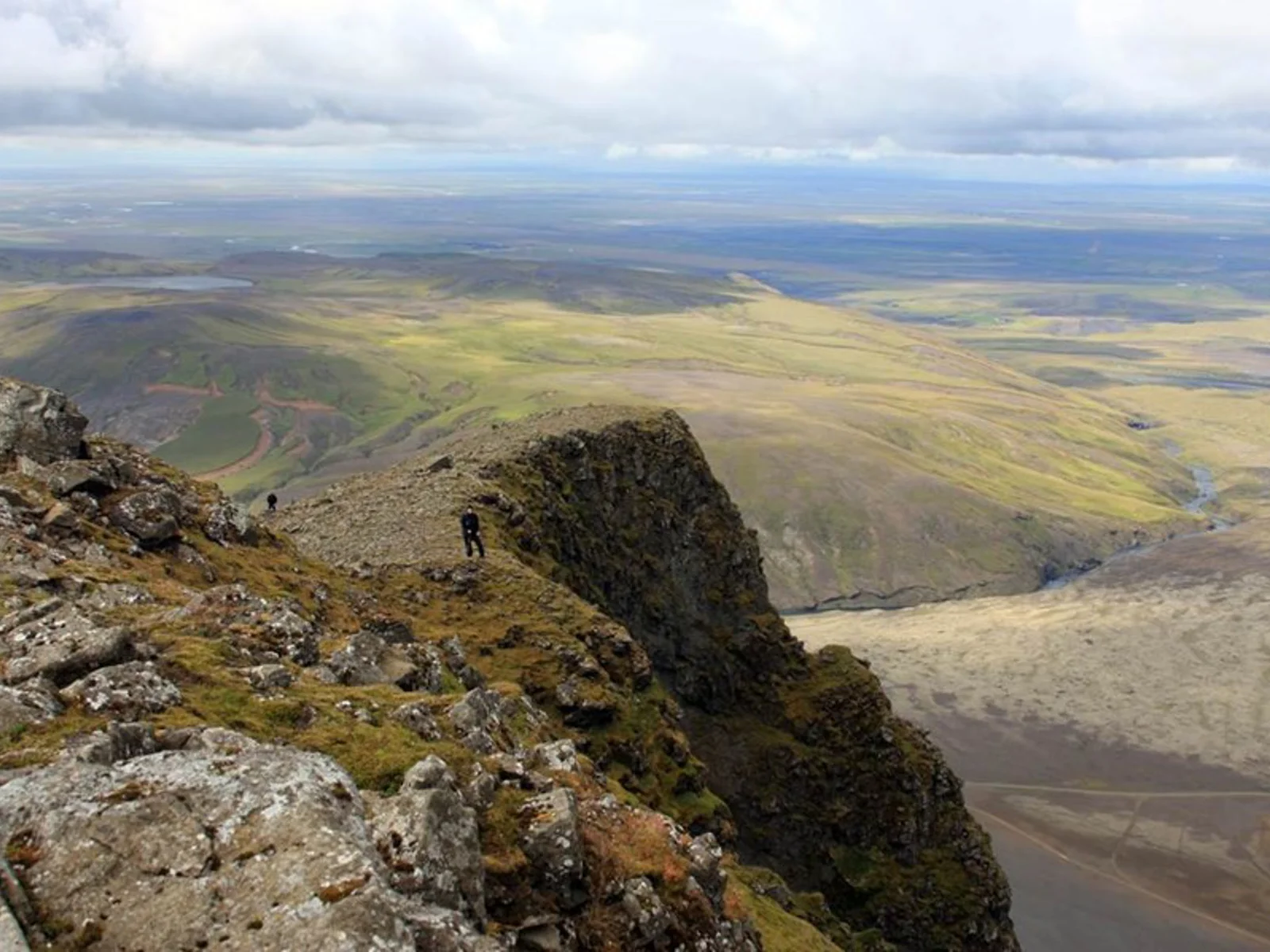 Rocky ridge and wide lowland view from Þríhyrningur mountain in South Iceland.