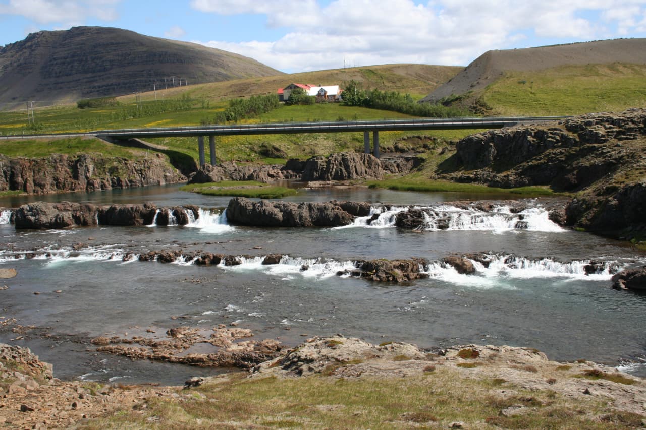 Low stepped cascades of Tröllafossar below the road bridge at Fossatún in West Iceland.