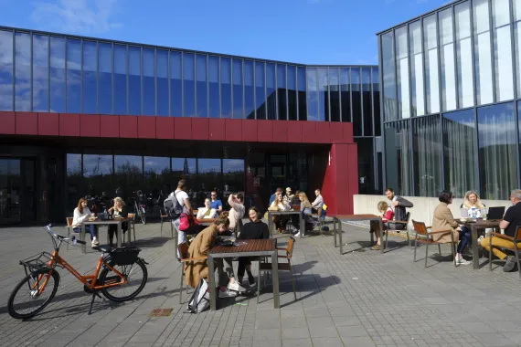 People seated outside the University Centre at the University of Iceland