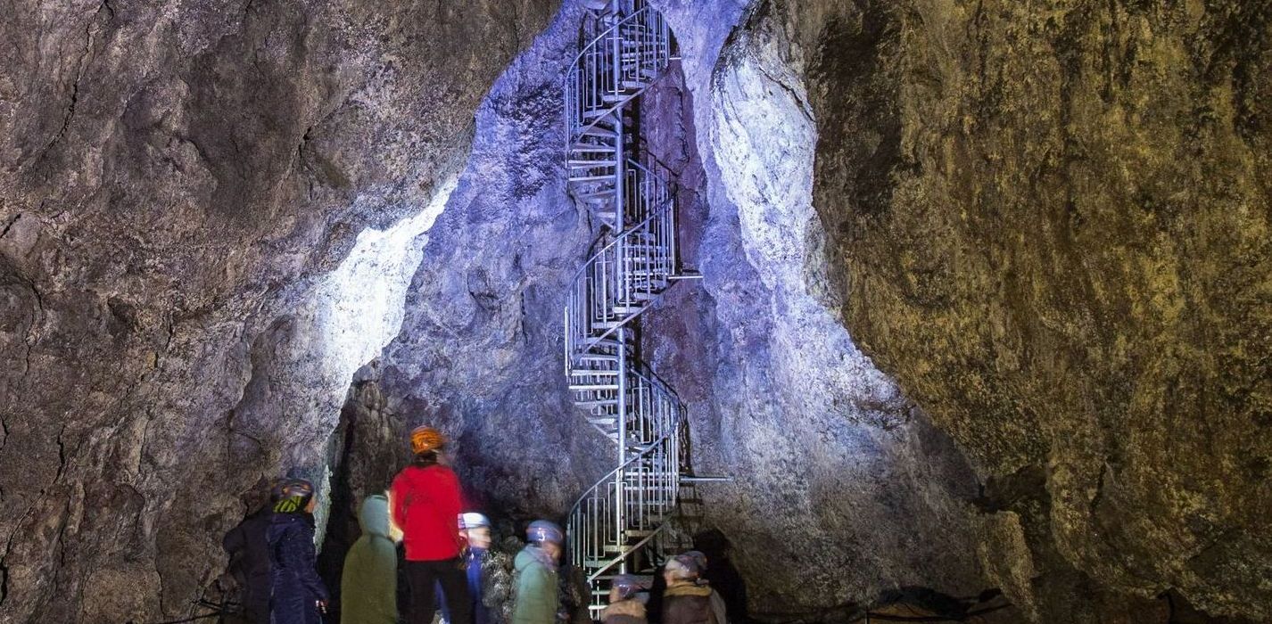 Visitors below the spiral staircase inside Vatnshellir Cave.