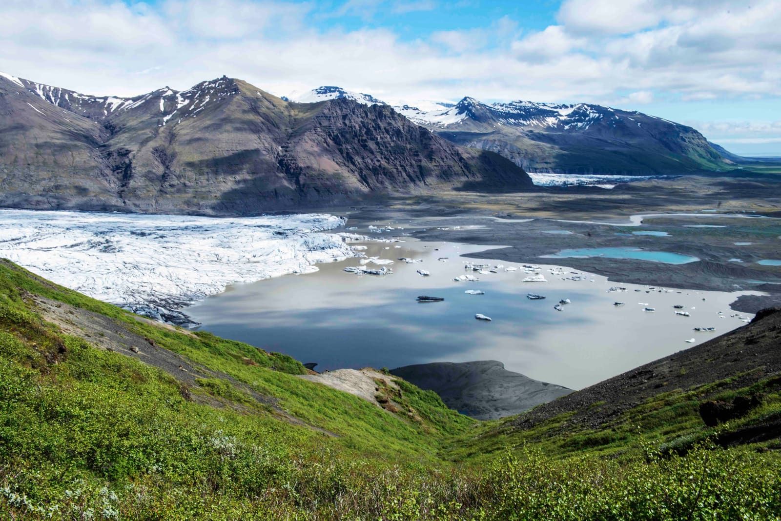 Steep Skaftafell slopes and glacier ice above the valley landscape near Vestragil.