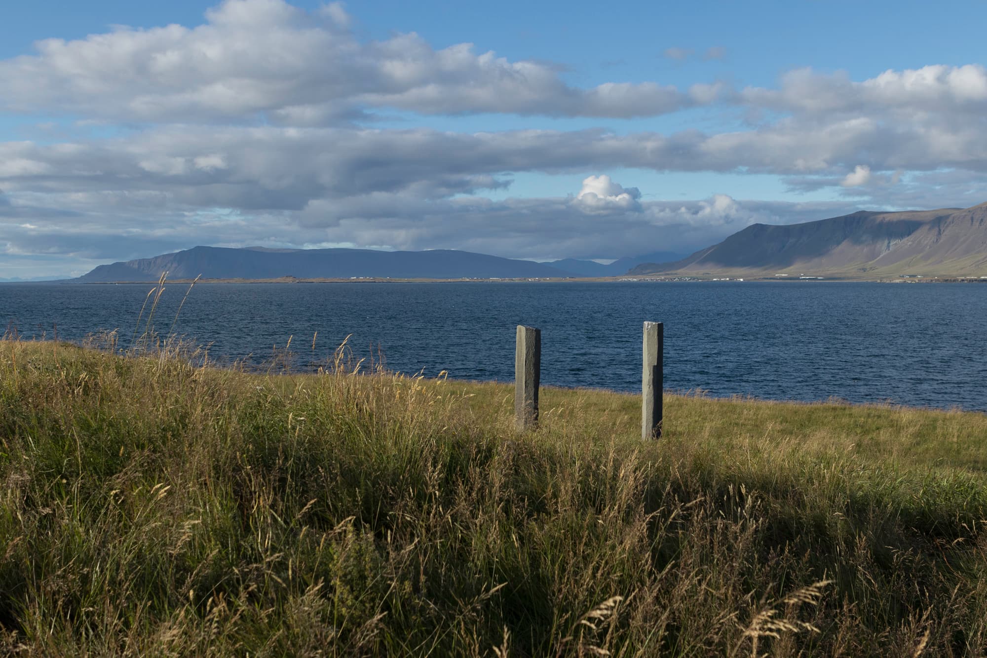 Basalt columns from Richard Serra's Áfangar on Viðey with mountains across the bay