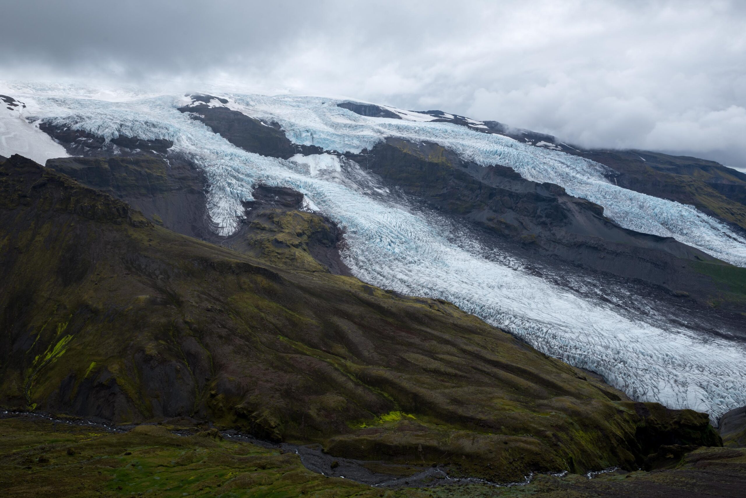 Virkisjökull and Falljökull descending between dark ridges near Skaftafell.
