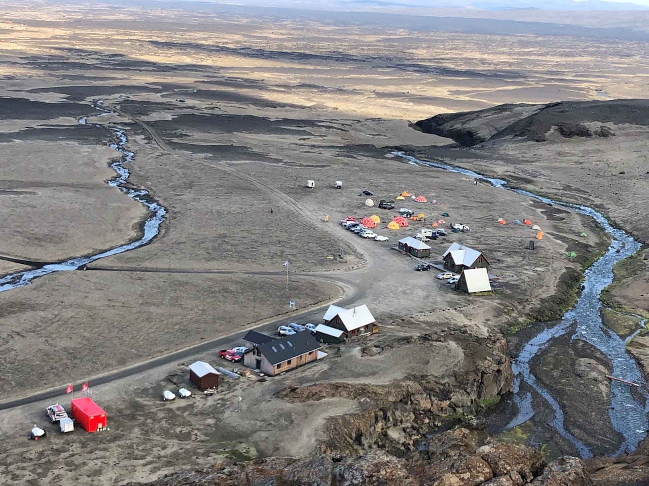Dreki huts, tents, vehicles, and tracks in the remote Highlands below Askja.